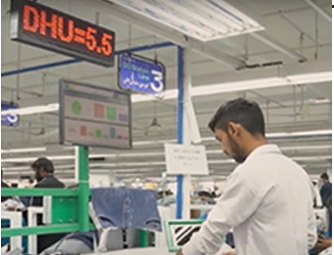 apparel factory worker using AI driven analytics to monitor production performance