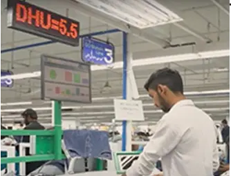 apparel factory worker using AI driven analytics to monitor production performance